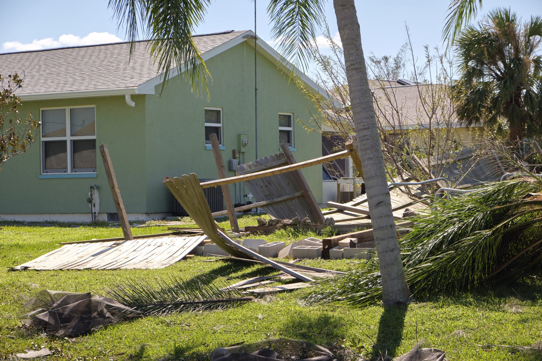 Home yard with scattered debris after hurricane Ian in Florida.